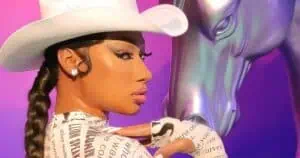 Las Vegas, Nevada, USA - 09, 07, 2025: Stunning wax figure of famous rapper Megan Thee Stallion wearing a western themed bodysuit and white cowboy hat standing by a silver horse and neon cactus